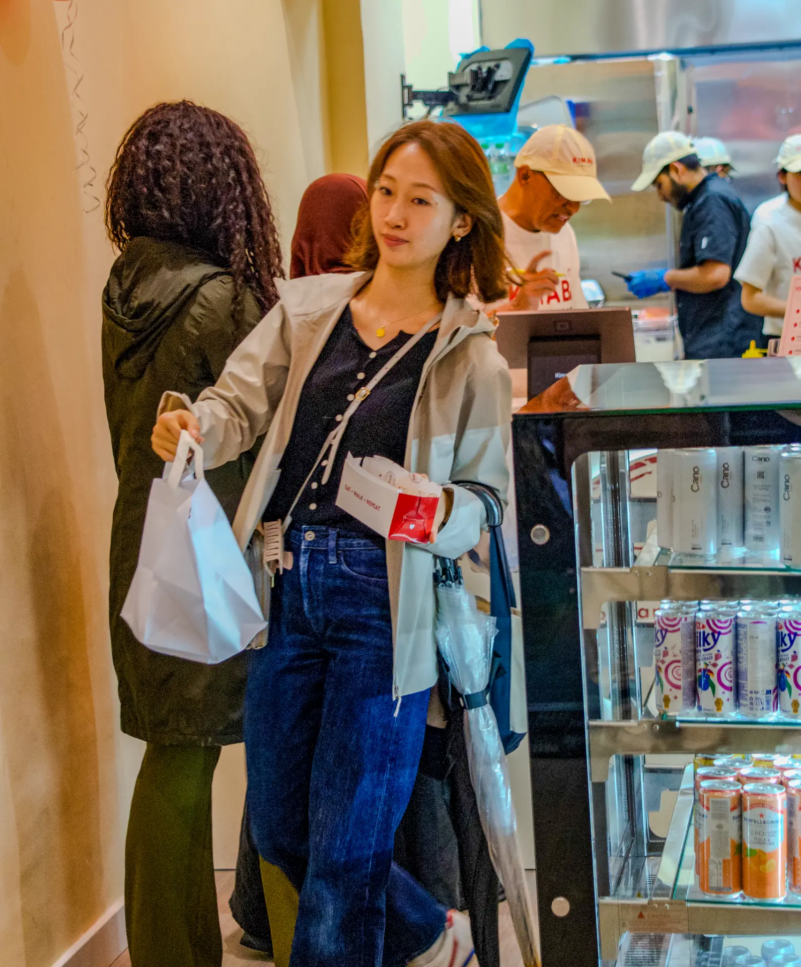 Customer collecting her Kimabi order at the counter